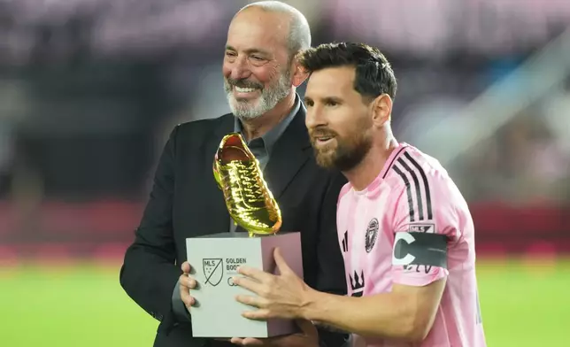 MLS Commissioner Don Garber presents the Golden Boot award to Inter Miami forward Lionel Messi before match one of an MLS playoff opening round soccer match against the Nashville SC, Friday, Oct. 24, 2025, in Fort Lauderdale, Fla. (AP Photo/Marta Lavandier)