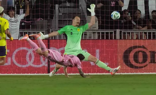 Inter Miami forward Lionel Messi (10) scores a goal against Nashville SC goalkeeper Joe Willis (1) during the first half of match one of their MLS playoff opening round soccer match, Friday, Oct. 24, 2025, in Fort Lauderdale, Fla. (AP Photo/Marta Lavandier)