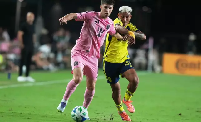 Inter Miami midfielder Baltasar Rodríguez (11) and Nashville SC midfielder Andy Najar (31) go after the ball during the first half of match one of their MLS playoff opening round soccer match, Friday, Oct. 24, 2025, in Fort Lauderdale, Fla. (AP Photo/Marta Lavandier)