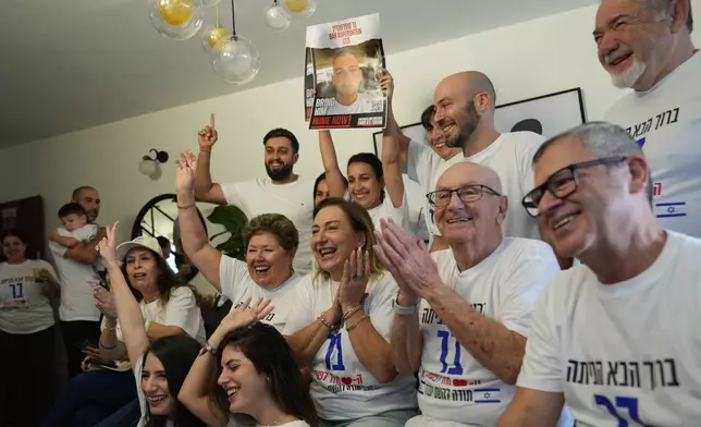 Family and friends of Israeli hostage Bar Kupershtein celebrate as they await the release of Kupershtein and other hostages from Hamas captivity in Gaza, in Holon, Israel, Monday, Oct. 13, 2025. (AP Photo/Francisco Seco)