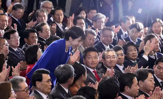 Former Economic Security Minister Sanae Takaichi, center left, bows as Takaichi was chosen to a new leader of Japan’s ruling Liberal Democratic Party during the party's leadership election in Tokyo, Japan, Saturday, Oct. 4, 2025. (Kyodo News via AP)