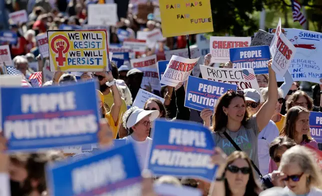 Marchers proceed from the Capitol during a rally protesting a proposed election redistricting map Tuesday, Oct. 21, 2025, in Raleigh, N.C. (AP Photo/Chris Seward)