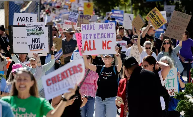 Marchers proceed from the Capitol during a rally protesting a proposed redistricting map Tuesday, Oct. 21, 2025, in Raleigh, N.C. (AP Photo/Chris Seward)