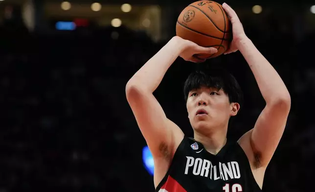 Portland Trail Blazers center Yang Hansen shoots during the first half of NBA basketball game against the Minnesota Timberwolves on Wednesday, Oct. 22, 2025, in Portland, Ore. It was his first point scored during a regular season NBA basketball game. (AP Photo/Jenny Kane)