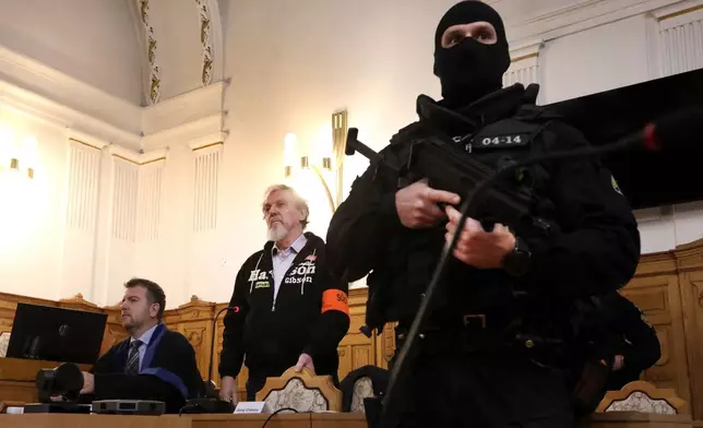 Juraj Cintula, centre, who shot and seriously injured Prime minister of Slovakia Robert Fico last year, attends hearings at the Specialized Criminal Court in Banska Bystrica, Slovakia, Tuesday, Oct. 21, 2025. (Jan Kroslak/TASR via AP)