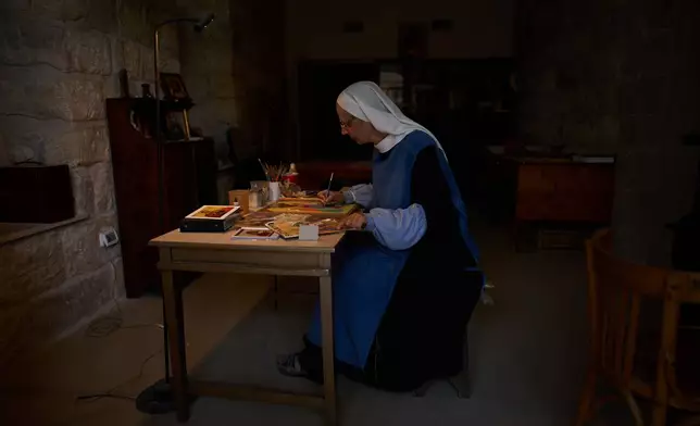 Sister Marie Benedicte, a Catholic nun, writes an icon in the Benedictine monastery on top of the Mount of Olives in Jerusalem, Friday, Oct. 17, 2025. (AP Photo/Oded Balilty)