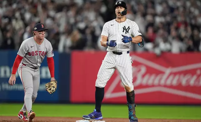 New York Yankees designated hitter Giancarlo Stanton reacts after hitting a double against the Boston Red Sox during the second inning of Game 3 of an American League wild-card baseball playoff series, Thursday, Oct. 2, 2025, in New York. (AP Photo/Frank Franklin II)
