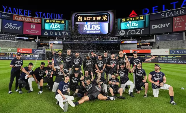 The New York Yankees pose for a team photo on the field after defeating the Boston Red Sox in Game 3 of an American League wild-card baseball playoff series, Thursday, Oct. 2, 2025, in New York. (AP Photo/Frank Franklin II)