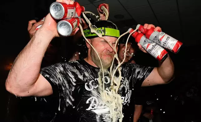 New York Yankees pitcher David Bednar (53) sprays himself with beer while celebrating with teammates after the Yankees defeated the Boston Red Sox in Game 3 of an American League wild-card baseball playoff series, Thursday, Oct. 2, 2025, in New York. (AP Photo/Yuki Iwamura)