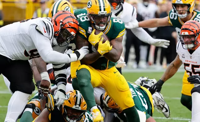 Green Bay Packers running back Josh Jacobs (8) scores a touchdown against the Cincinnati Bengals in the first half of an NFL football game, Sunday, Oct. 12, 2025, in Green Bay, Wis. (AP Photo/Mike Roemer)