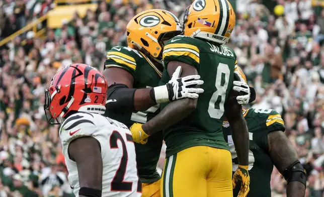 Green Bay Packers running back Josh Jacobs (8) celebrates his touchdown against the Cincinnati Bengals in the second half of an NFL football game, Sunday, Oct. 12, 2025, in Green Bay, Wis. (AP Photo/Morry Gash)