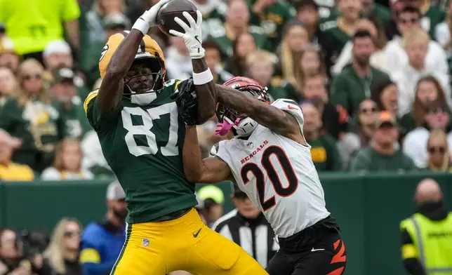 Green Bay Packers wide receiver Romeo Doubs (87) works for a catch against Cincinnati Bengals cornerback DJ Turner II (20) in the first half of an NFL football game, Sunday, Oct. 12, 2025, in Green Bay, Wis. (AP Photo/Morry Gash)