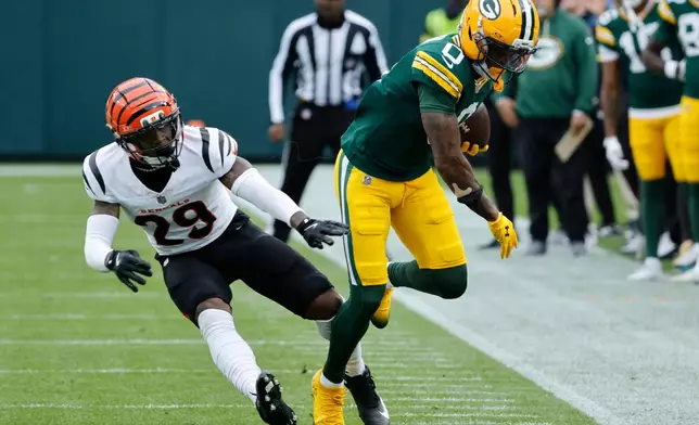 Green Bay Packers' Matthew Golden (0) runs after a catch aqgainst Cincinnati Bengals cornerback Josh Newton (28) in the first half of an NFL football game, Sunday, Oct. 12, 2025, in Green Bay, Wis. (AP Photo/Mike Roemer)