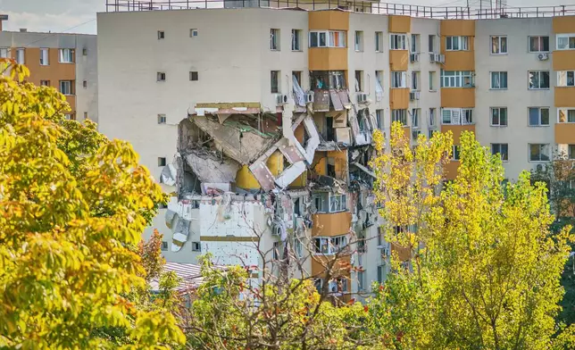 A view of of a damaged apartment building after powerful gas explosion in a residential block in Bucharest, Romania, Friday, Oct. 17, 2025. (AP Photo)