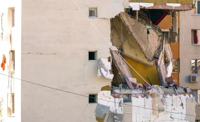 A view of of a damaged apartment building after a powerful explosion in a residential block in Bucharest, Romania, Friday, Oct. 17, 2025. (AP Photo)