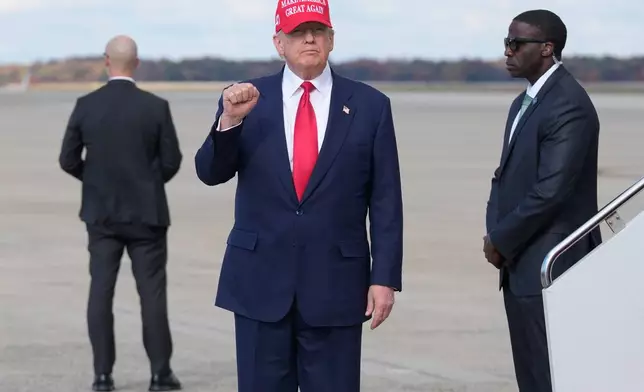 President Donald Trump gestures as he arrives on Air Force One, Thursday, Oct. 30, 2025, at Joint Base Andrews, Md., after returning from a trip to Asia. (AP Photo/Mark Schiefelbein)