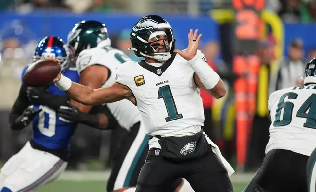 Philadelphia Eagles' Jalen Hurts plays during the first half of an NFL football game against the New York Giants Thursday, Oct. 9, 2025, in East Rutherford, N.J. (AP Photo/Seth Wenig)
