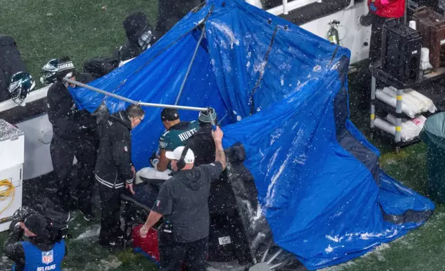 FILE - Philadelphia Eagles quarterback Jalen Hurts (1) sits as they pull the blue tent over him during the NFL divisional playoff football game against the Los Angeles Rams, Jan. 19, 2025, in Philadelphia. (AP Photo/Chris Szagola, File)