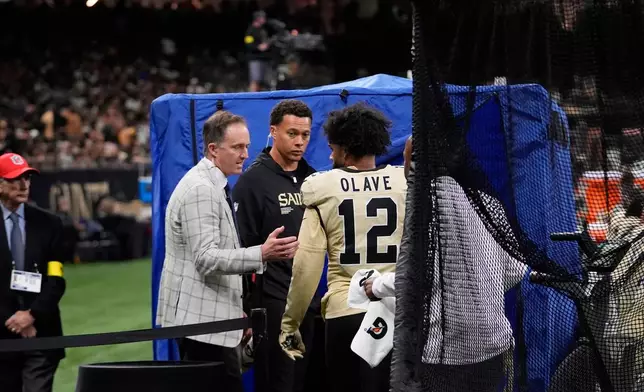 FILE - New Orleans Saints wide receiver Chris Olave (12) enters the medical tent before being examined after a hard hit in the second half of an NFL football game against the Arizona Cardinals, Sept. 7, 2025 in New Orleans. (AP Photo/Gerald Herbert, File)