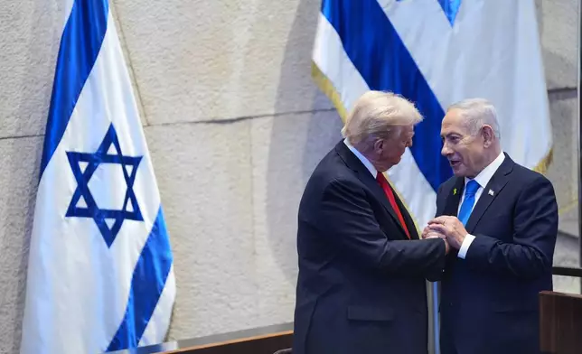 President Donald Trump talks with Israel's Prime Minister Benjamin Netanyahu at the Knesset, Israel's parliament, Monday, Oct. 13, 2025, in Jerusalem. (AP Photo/Evan Vucci, Pool)