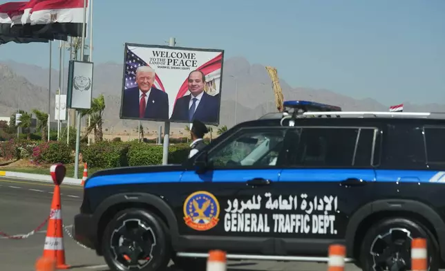 A police vehicle in front of a poster showing Egyptian President Abdel-Fattah el-Sissi and U.S. President Donald Trump at the Red Sea city of Sharm el-Sheikh, Egypt, Monday, Oct. 13, 2025. (AP Photo/Amr Nabil)