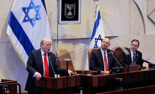 President Donald Trump addresses the Knesset, Israel's parliament, next to Amir Ohana, Speaker of the Israeli Knesset, and Israeli President Isaac Herzog, Monday, Oct. 13, 2025, in Jerusalem. (Chip Somodevilla/Pool via AP)