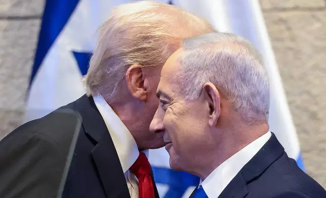 President Donald Trump talks with Israel's Prime Minister Benjamin Netanyahu at the Knesset, Israel's parliament, Monday, Oct. 13, 2025, in Jerusalem. (Evelyn Hockstein/Pool via AP)