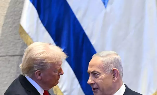 President Donald Trump talks with Israel's Prime Minister Benjamin Netanyahu at the Knesset, Israel's parliament, Monday, Oct. 13, 2025, in Jerusalem. (Saul Loeb/Pool via AP)