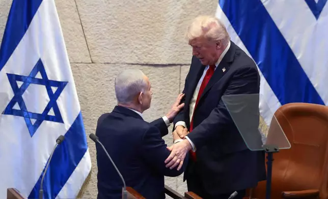 President Donald Trump talks with Israel's Prime Minister Benjamin Netanyahu at the Knesset, Israel's parliament, Monday, Oct. 13, 2025, in Jerusalem. (Evelyn Hockstein/Pool via AP)