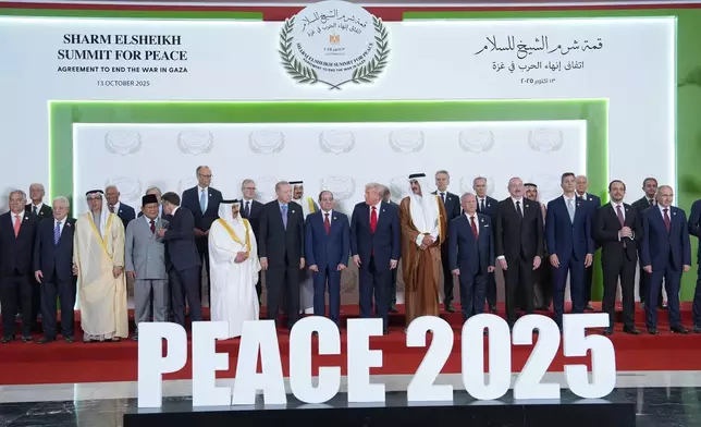 President Donald Trump and other world leaders pose for a photo during a summit to support ending the more than two-year Israel-Hamas war in Gaza after a breakthrough ceasefire deal, Monday, Oct. 13, 2025, in Sharm El Sheikh, Egypt. (AP Photo/Evan Vucci, Pool)