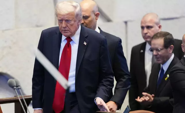 President Donald Trump enters the Knesset, Israel's parliament, with Israel's President Isaac Herzog and Israel's Prime Minister Benjamin Netanyahu, right, before he speaks Monday, Oct. 13, 2025, in Jerusalem. (AP Photo/Evan Vucci, Pool)