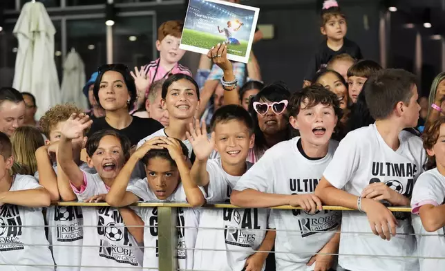 Fans cheer while Inter Miami's Lionel Messi warms up before an MLS soccer match against Atlanta United, Saturday, Oct. 11, 2025, in Fort Lauderdale, Fla. (AP Photo/Lynne Sladky)