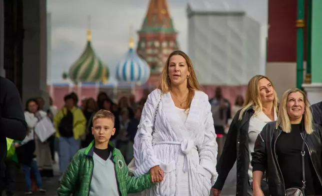 FILE - People walk from Red Square with St. Basil's Cathedral in the background in Moscow, Russia, Thursday, Aug. 14, 2025. (AP Photo/Alexander Zemlianichenko, File)