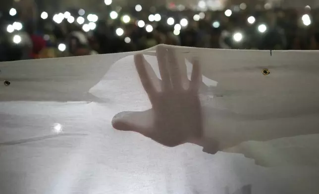 FILE - Students march on New Years Eve during a protest that erupted after a concrete canopy fell two months ago, in Belgrade, Serbia, Dec. 31, 2024. (AP Photo/Darko Vojinovic, File)