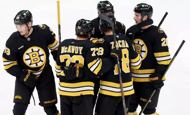 Boston Bruins celebrate a goal by center Morgan Geekie (39) during the third period of an NHL hockey game against the New York Islanders, Tuesday, Oct. 28, 2025, in Boston. (AP Photo/Mark Stockwell)
