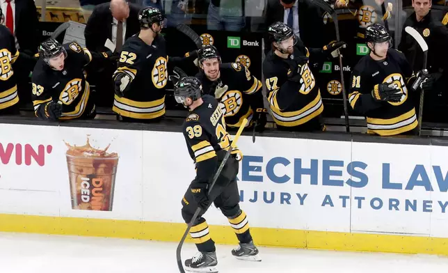 Boston Bruins center Morgan Geekie (39) celebrates his goal during the third period of an NHL hockey game against the New York Islanders, Tuesday, Oct. 28, 2025, in Boston. (AP Photo/Mark Stockwell)