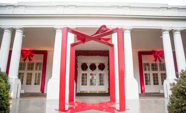 FILE - A large ribbon is displayed outside the East Wing of the White House during a preview of the 2016 holiday decor, Nov. 29, 2016, in Washington. (AP Photo/Andrew Harnik, File)