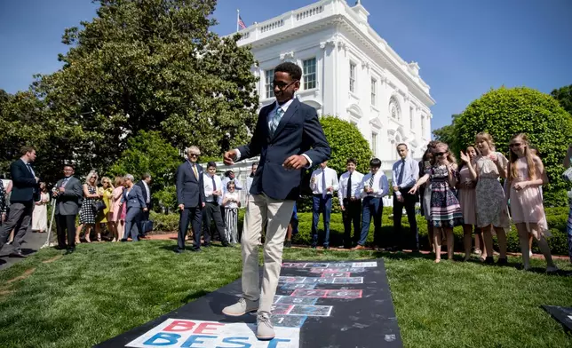 FILE - Invited guests play at the Jacqueline Kennedy Garden as part of a one year anniversary event for first lady Melania Trump's Be Best initiative, May 7, 2019, at the White House in Washington. (AP Photo/Andrew Harnik, File)