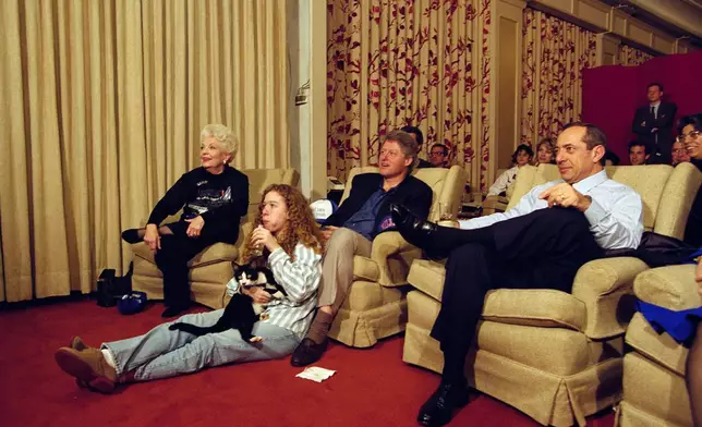 FILE - President Bill Clinton, flanked by Governors Ann Richards of Texas, left, and Mario Cuomo of New York, watches the Dallas Cowboys and Buffalo Bills play in the Super Bowl with his daughter Chelsea and their cat, Socks, in the White House, Jan. 31, 1993, in the family theater. (AP Photo/Wilfredo Lee, File)