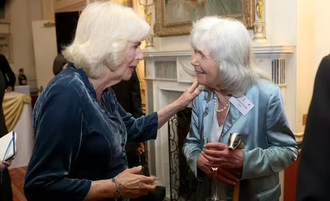 This March 25, 2025 file photo shows Queen Camilla, left, and Dame Jilly Cooper during a reception at Clarence House, London. (Chris Jackson/PA via AP)