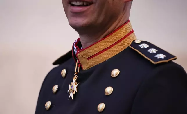 Captain Lorenz Keusch poses for reporters during the presentation of the Swiss Guard Mezza-Gala uniform in the Swiss Guard Barracks at the Vatican, Thursday, Oct. 2, 2025. (AP Photo/Alessandra Tarantino)