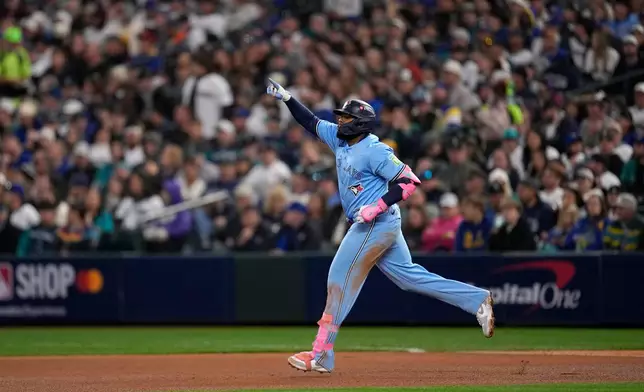 Toronto Blue Jays' Vladimir Guerrero Jr. rounds the bases after hitting a solo home run against the Seattle Mariners during the fifth inning in Game 3 of baseball's American League Championship Series, Wednesday, Oct. 15, 2025, in Seattle. (AP Photo/David J. Phillip)