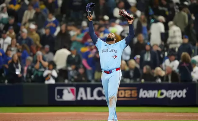 Toronto Blue Jays' Vladimir Guerrero Jr. (27) celebrates after the final out to defeat the Seattle Mariners in Game 3 of baseball's American League Championship Series, Wednesday, Oct. 15, 2025, in Seattle. (Frank Gunn/The Canadian Press via AP)