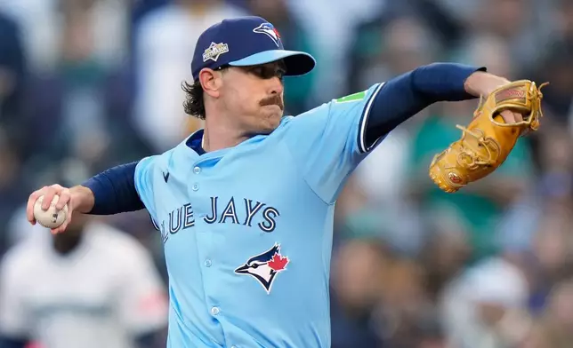 Toronto Blue Jays pitcher Shane Bieber (57) delivers a pitch against the Seattle Mariners during first inning Game 3 American League Championship Series baseball action in Seattle on Wednesday, Oct. 15, 2025. (Frank Gunn/The Canadian Press via AP)