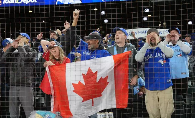 Toronto Blue Jays fans celebrate after the Blue Jays defeated the Seattle Mariners in Game 3 of baseball's American League Championship Series, Wednesday, Oct. 15, 2025, in Seattle. (Frank Gunn/The Canadian Press via AP)