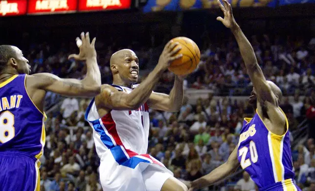 FILE - Detroit Pistons Chauncey Billups (1) goes to the basket between Los Angeles Lakers Kobe Bryant (8) and Gary Payton (20) in the first half of Game 3 of the NBA finals at the Palace in Auburn Hills, Mich., June 10, 2004. (AP Photo/Michael Conroy, File)
