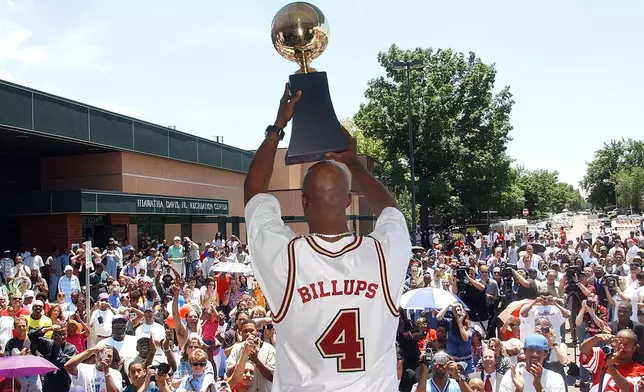 FILE - Denver native Chauncey Billups holds his MVP trophy for fans to see during a ceremony where he was honored in the Park Hill neighborhood of Denver on July 1, 2004. (AP Photo/Ed Andrieski, file)
