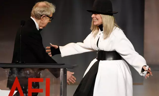 FILE - Filmmaker Woody Allen, left, greets actress Diane Keaton onstage to present her with the 45th AFI Life Achievement Award on June 8, 2017, in Los Angeles. (Photo by Chris Pizzello/Invision/AP, File)