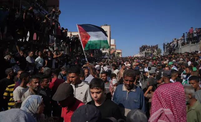 People gather to greet freed Palestinian prisoners as they arrive in the Gaza Strip after their release from Israeli jails under a ceasefire agreement between Hamas and Israel, outside Nasser Hospital in Khan Younis, southern Gaza Strip, Monday, Oct. 13, 2025. (AP Photo/Abdel Kareem Hana)