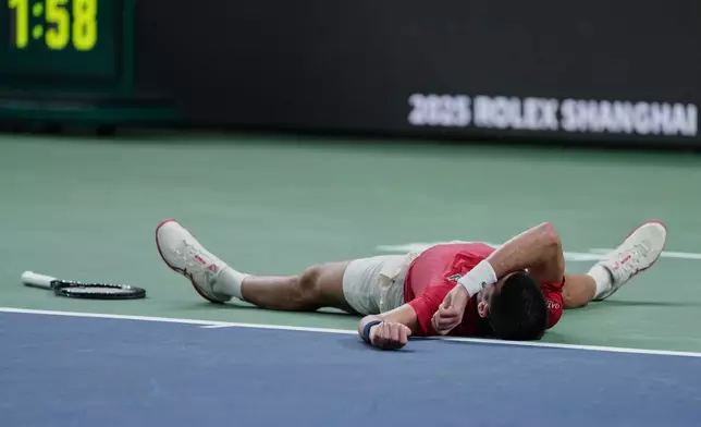 Novak Djokovic of Serbia reacts after losing the second set point to Jaume Munar of Spain during the men's singles match of the Shanghai Masters tennis tournament at Qizhong Forest Sports City Tennis Center, in Shanghai, China, Tuesday, Oct. 7, 2025. (AP Photo/Andy Wong)